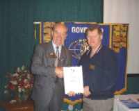 Alan Paterson (Lt. Governor Division 1) receives banner patch